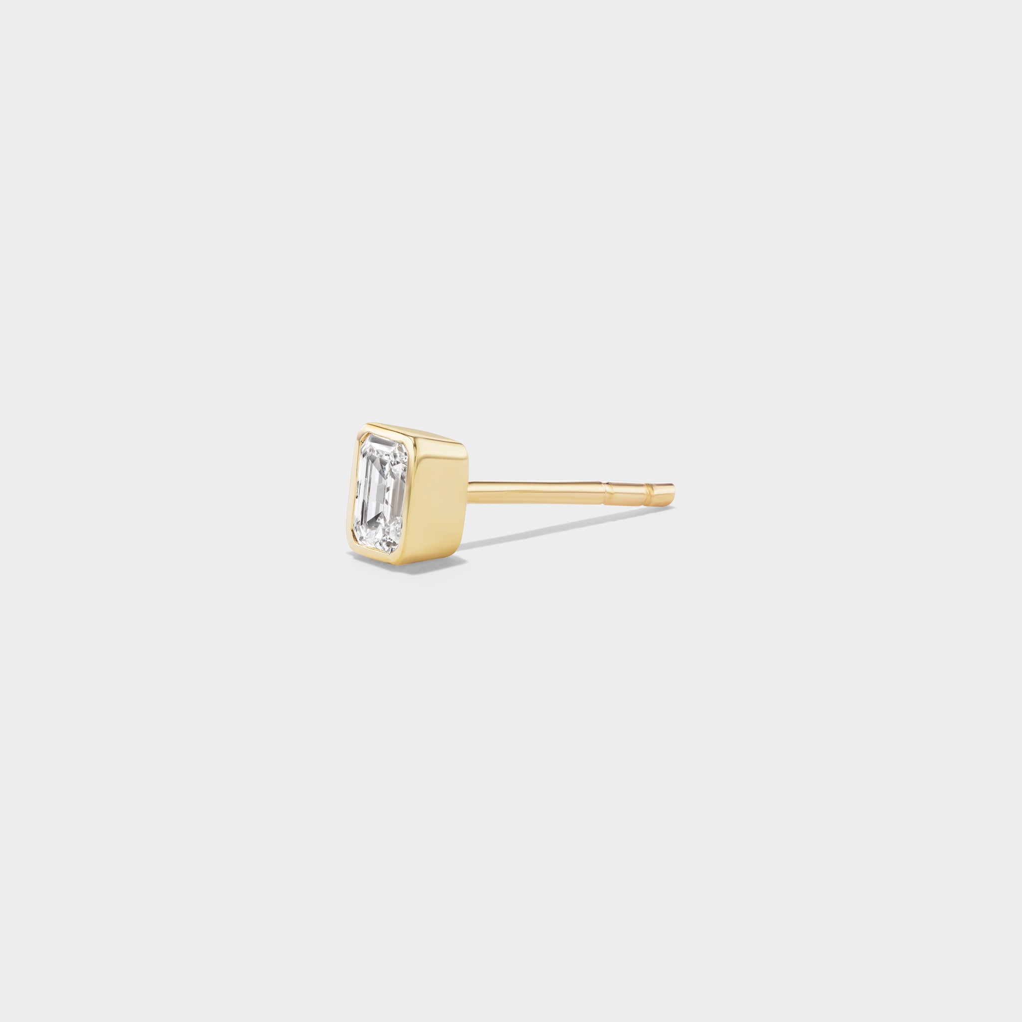 14k yellow gold mini stud with an emerald-cut lab diamond in a sleek bezel setting, perfect for an ear stack.