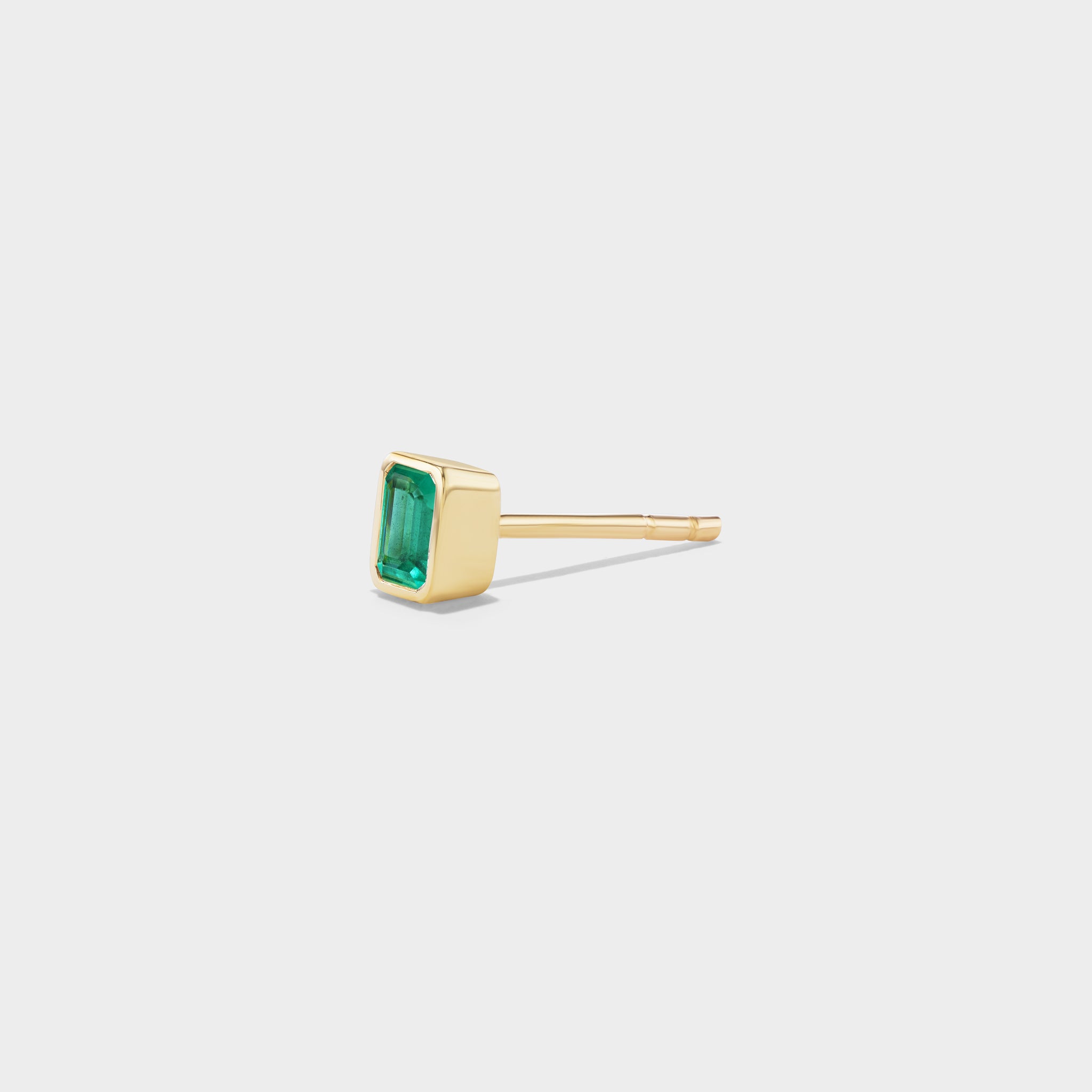 Emerald Bezel Mini Stud in 14k yellow gold, featuring a rectangular emerald for an everyday ear stack.