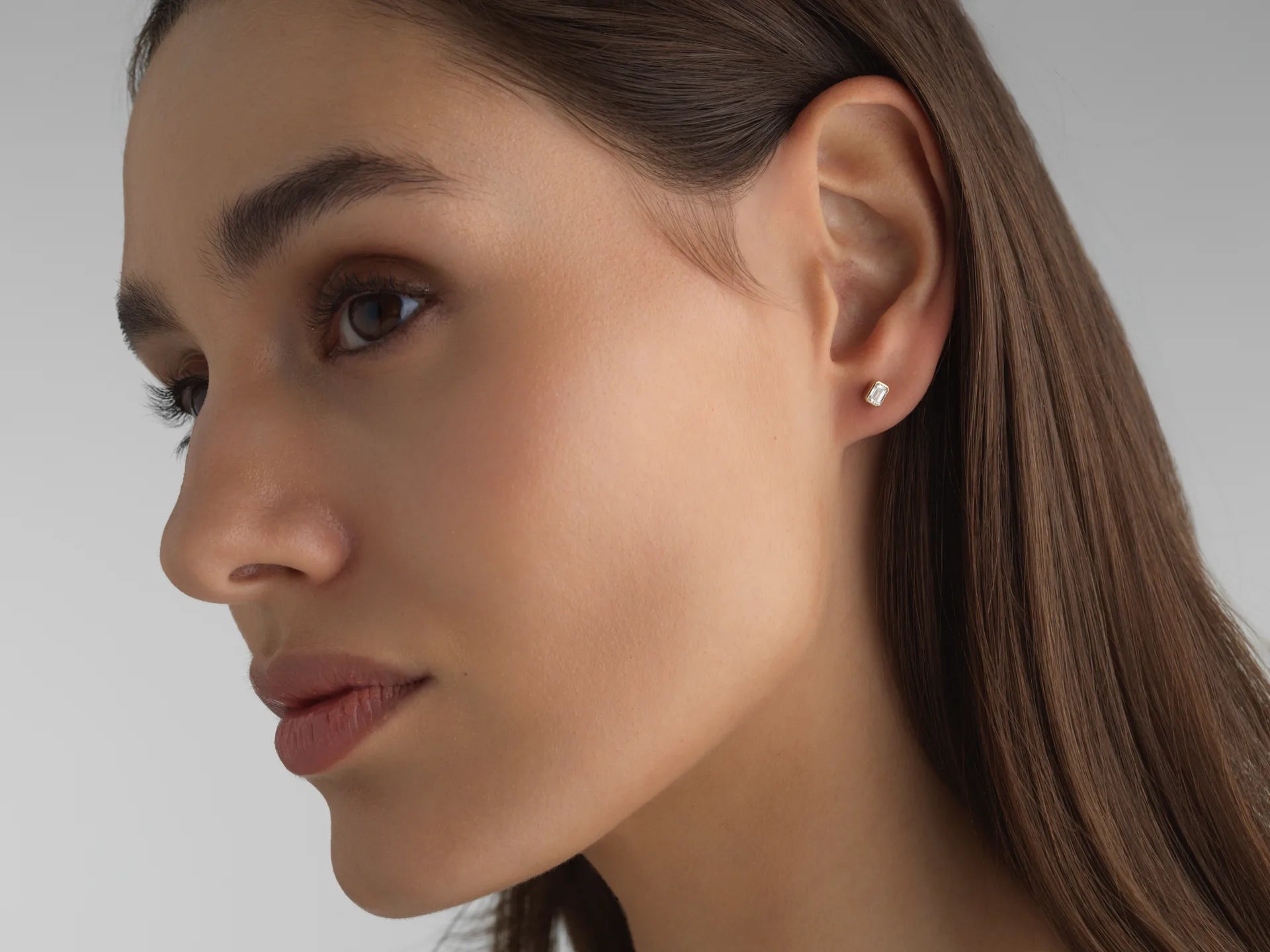 Everyday mini emerald-cut lab diamond stud in 14k white gold, perfect for an ear stack.