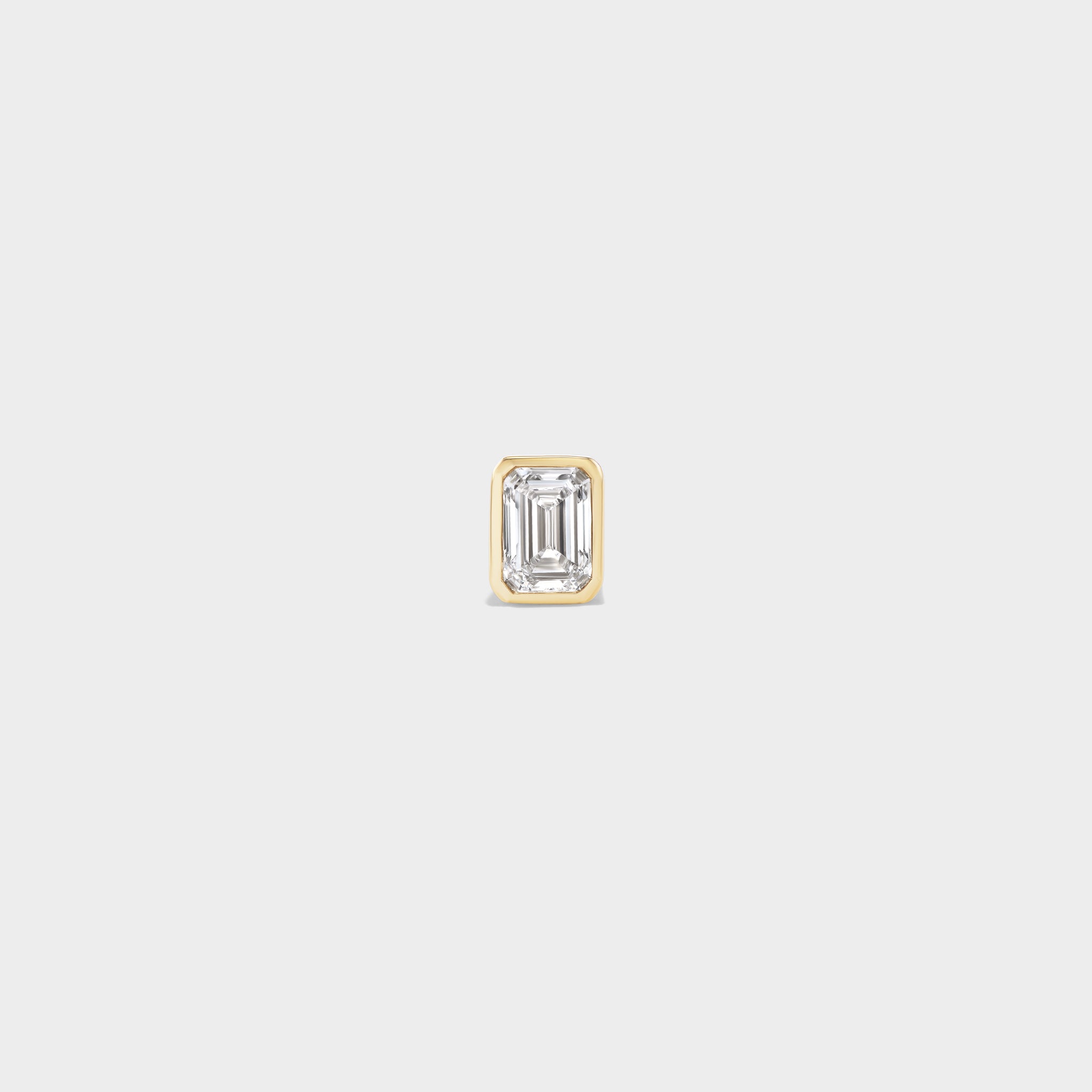Everyday mini emerald-cut lab diamond stud in 14k yellow gold, perfect for an ear stack.