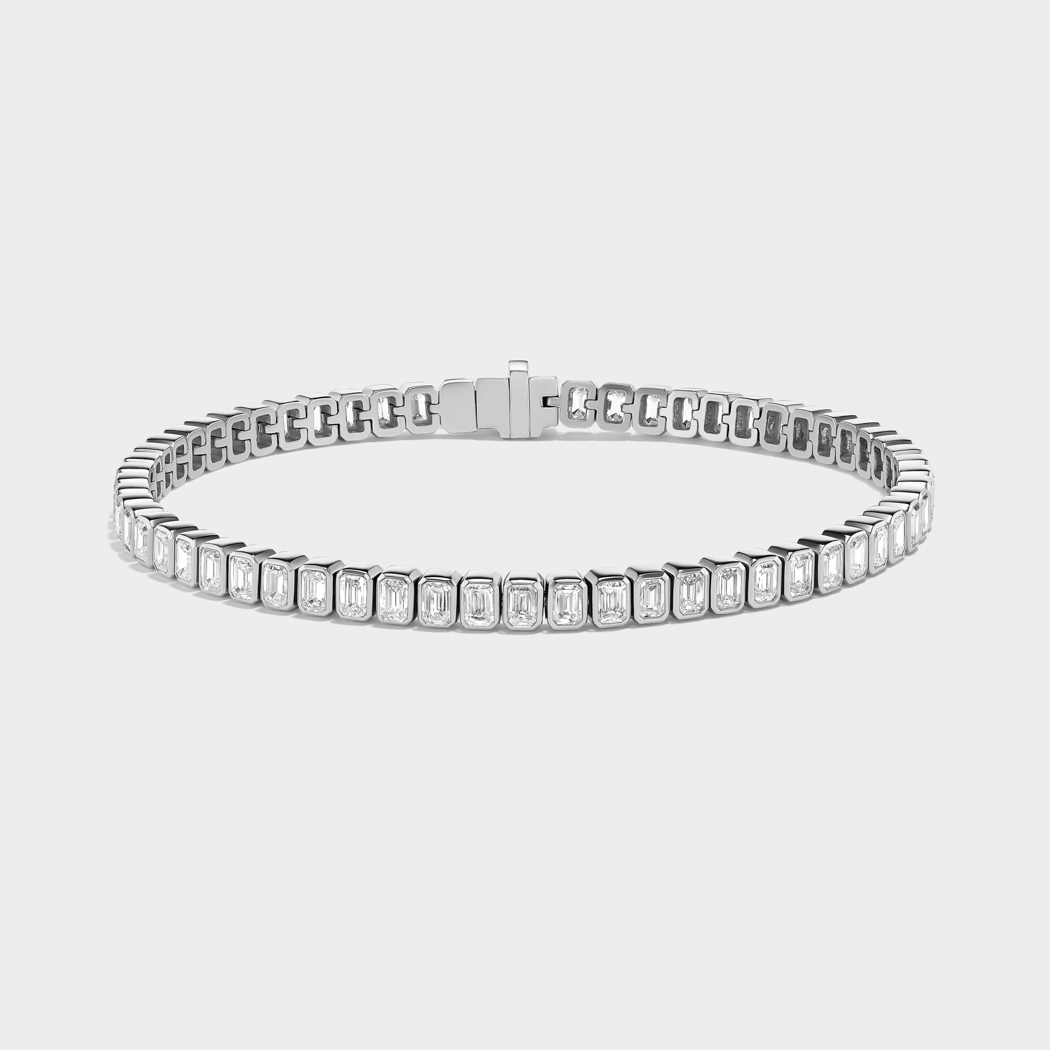 14K white gold emerald-cut lab-grown diamond bezel tennis bracelet with a discreet safety clasp.