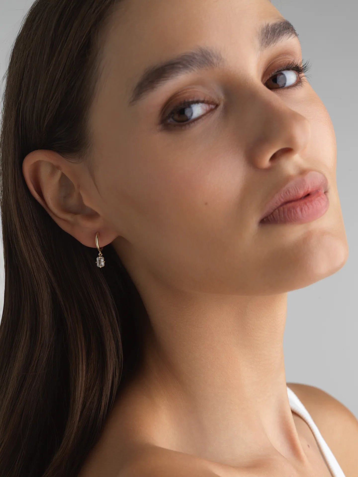 Everyday 14K yellow gold huggie earrings with emerald-cut lab diamonds, perfect for an ear stack.