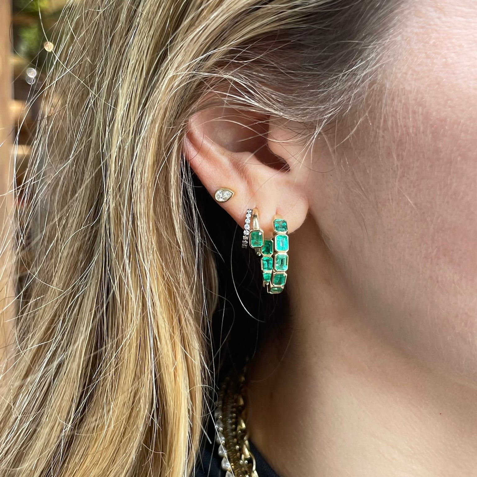 Emerald inside-out hoops in 14k yellow gold, perfect for everyday wear or stacking.