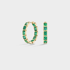Everyday 14k yellow gold inside-out hoops with bezel-set emerald-cut Brazilian emeralds.