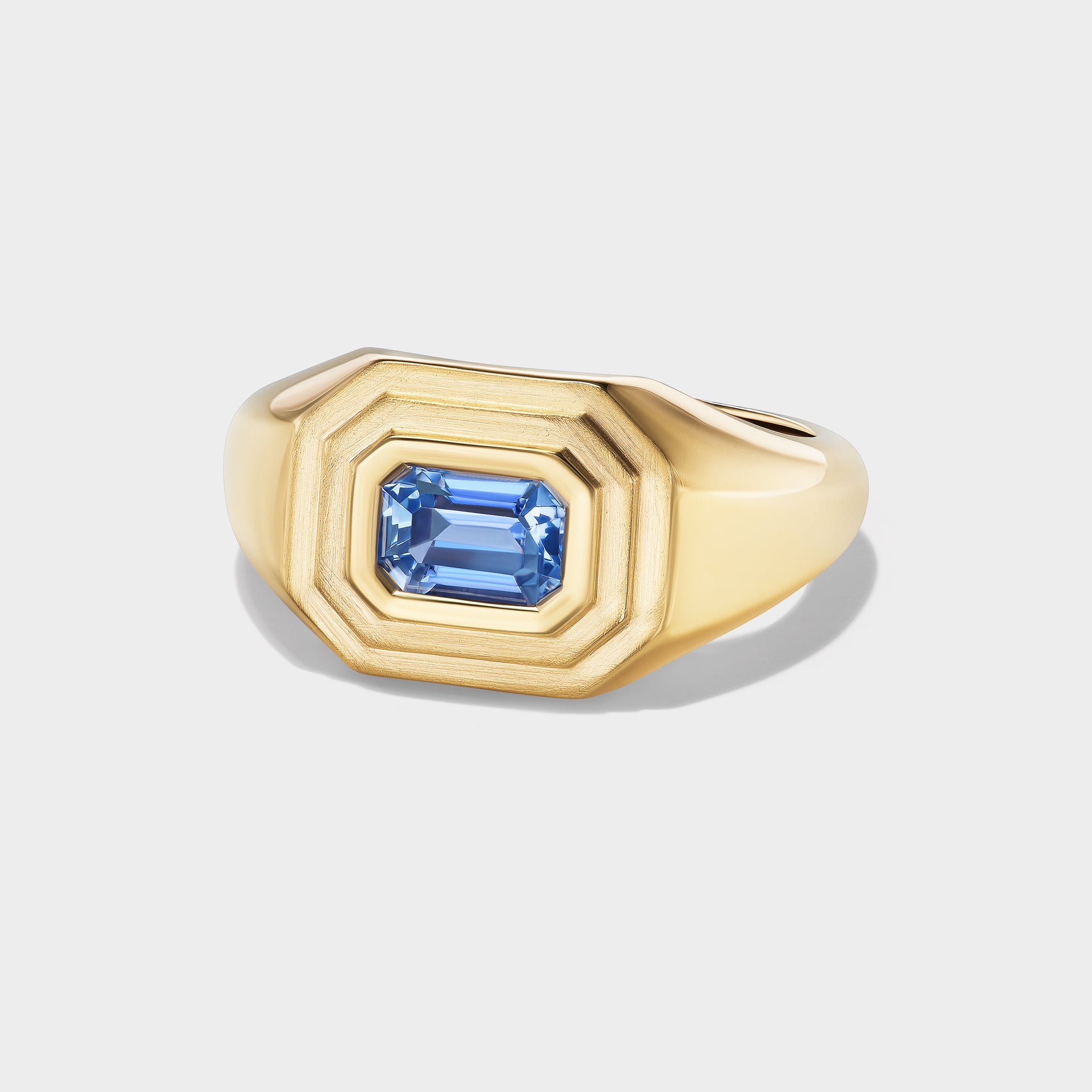14K recycled yellow gold signet ring with an emerald-cut blue sapphire, perfect as a pinky ring.