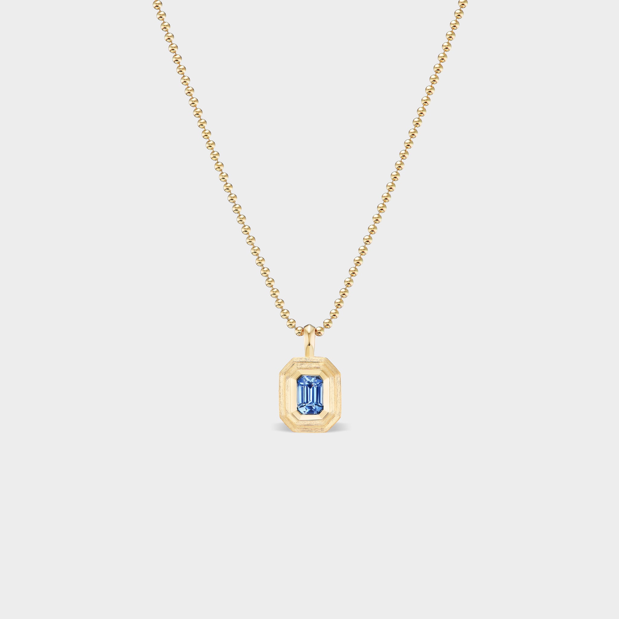 14K gold Mini Emerald Bezel Charm with natural blue sapphire, perfect for everyday wear.