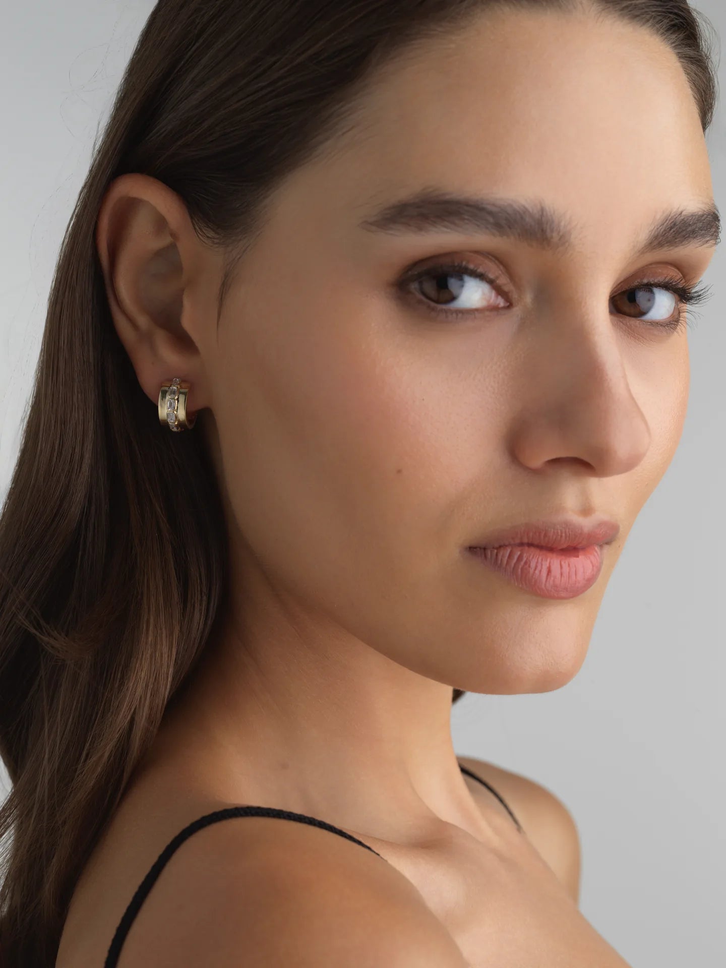 Everyday 14k white gold mini hoops with bezel-set emerald-cut lab diamonds, ideal for an ear stack.