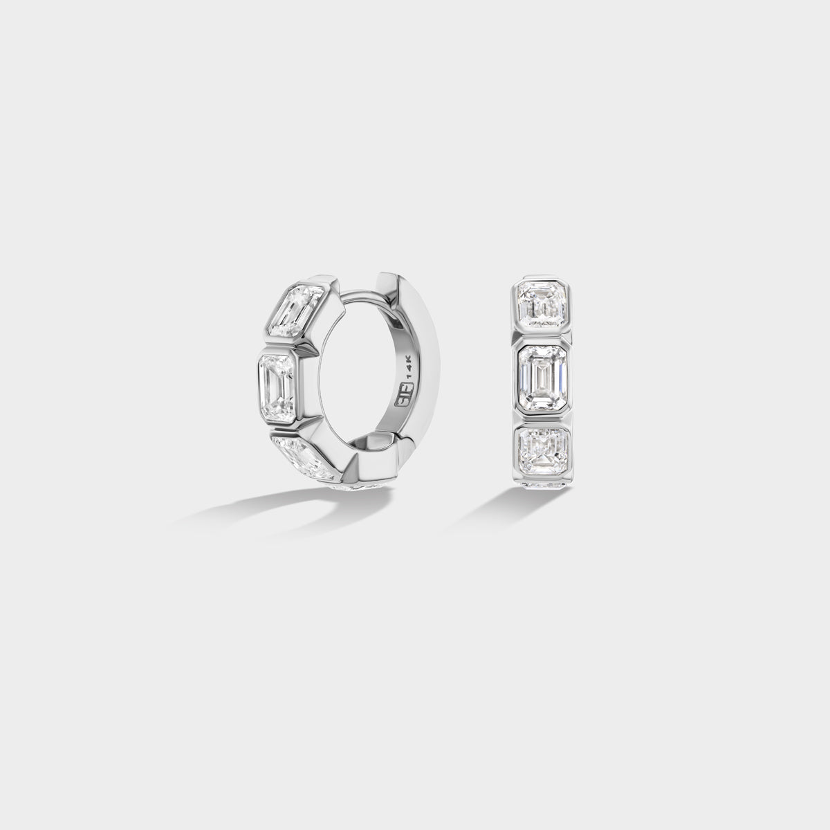 Mini 14K white gold huggie hoops with bezel-set emerald-cut lab-grown diamonds, perfect for an ear stack.