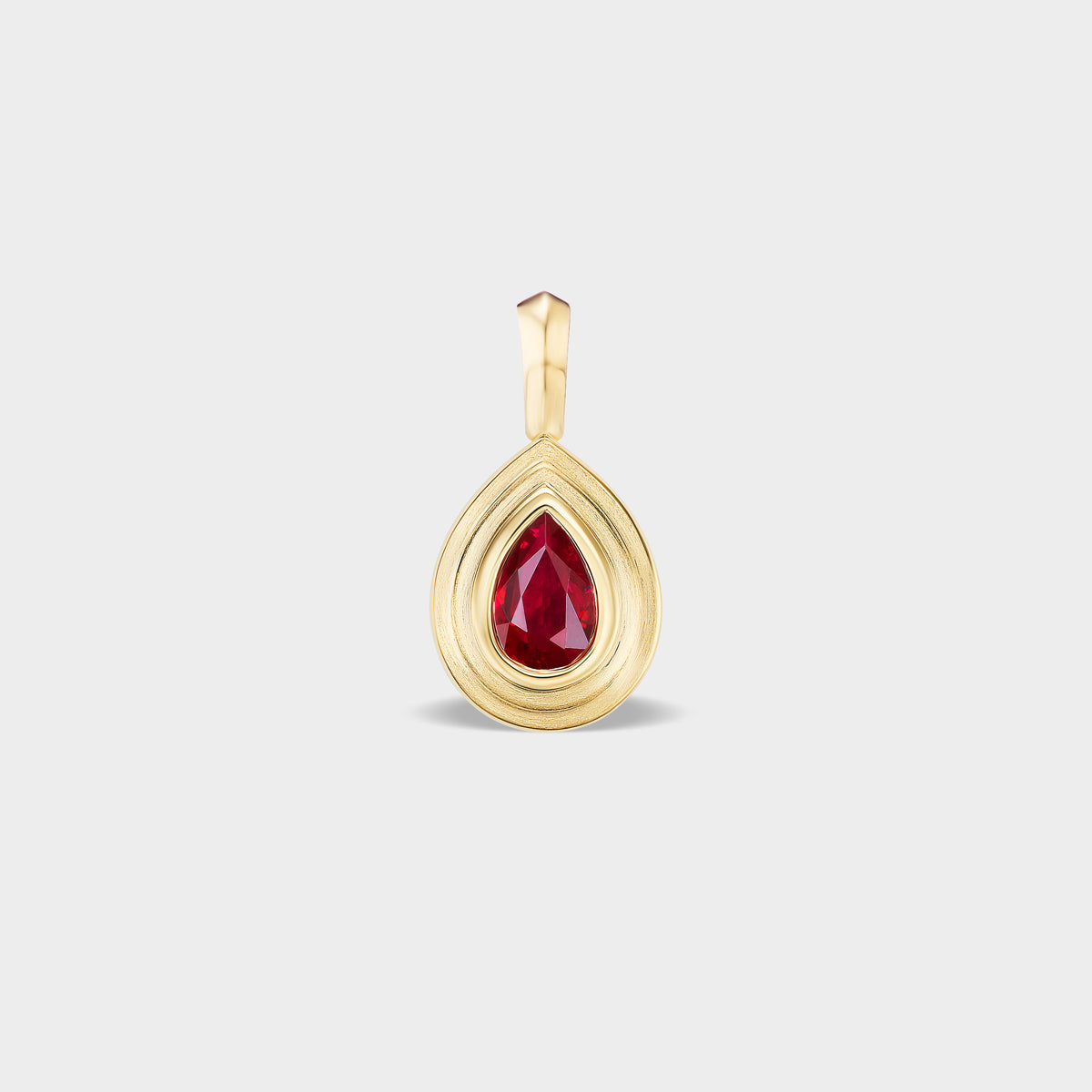 Mini 14K gold pear bezel charm with natural ruby, perfect for everyday wear or layering.