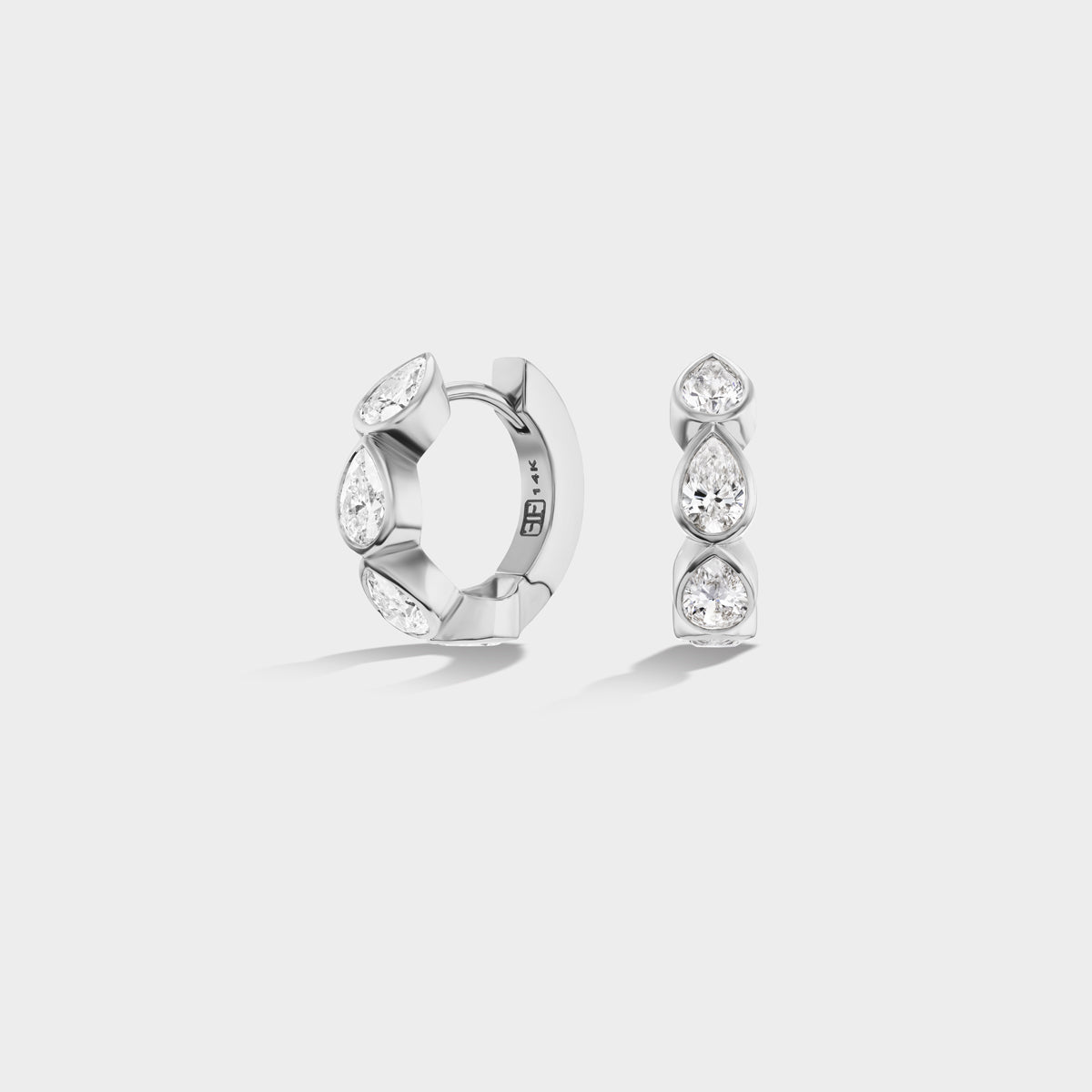 Everyday mini 14K white gold huggie earrings with bezel-set pear-cut lab-grown diamonds, ideal for an ear stack.