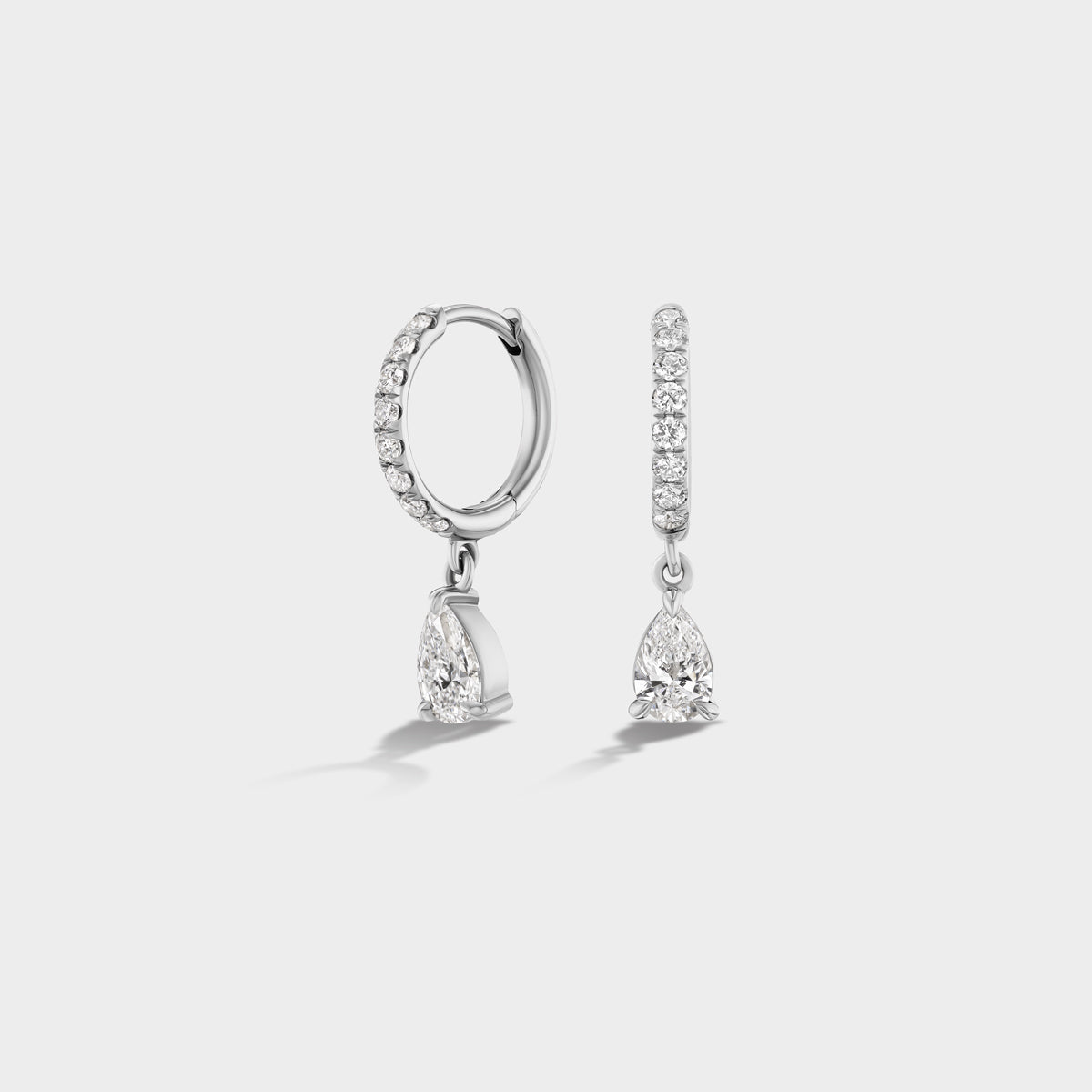 Everyday 14K white gold huggie earrings with pear-cut and round lab diamonds, perfect for stacking.
