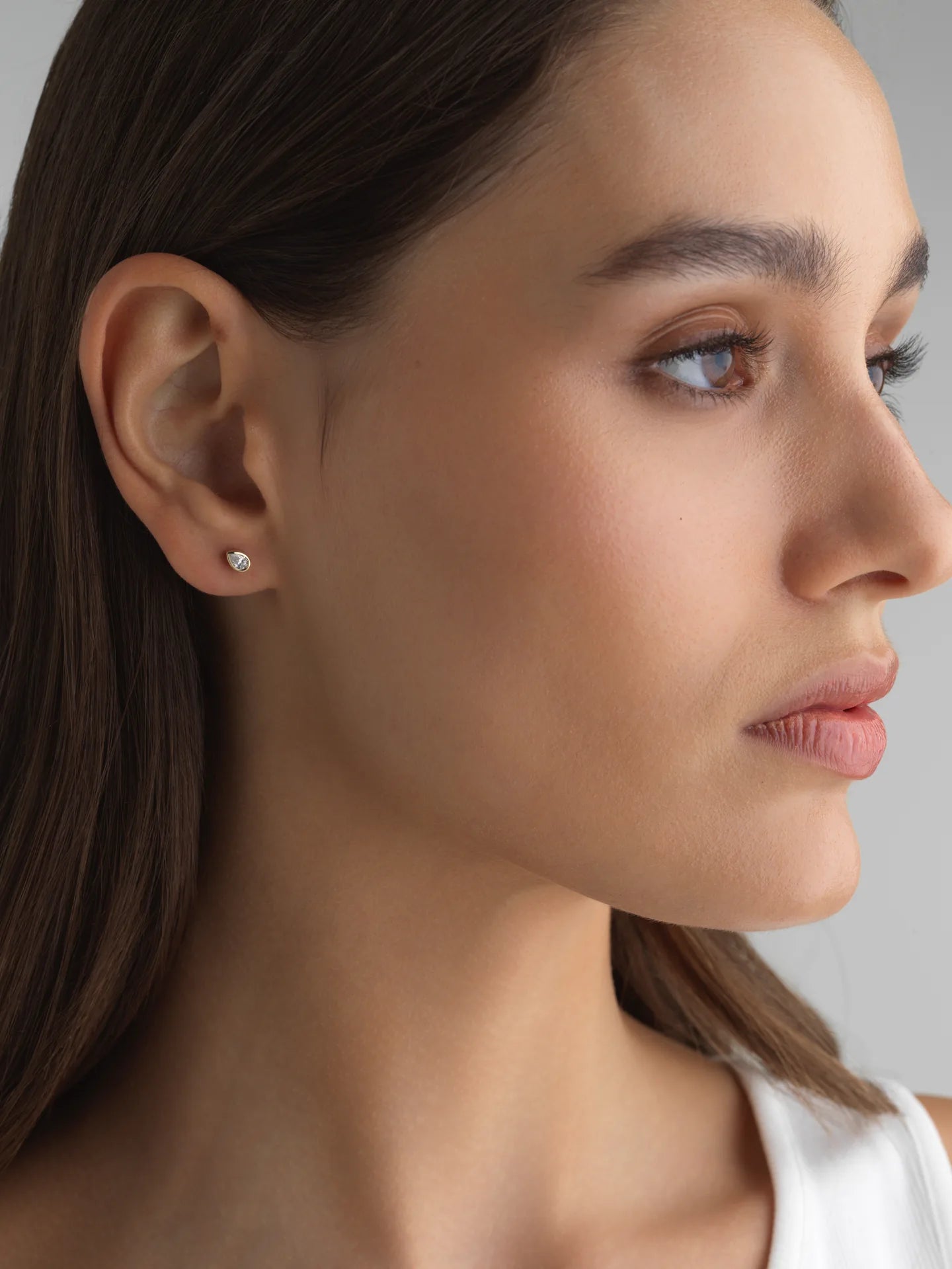 Everyday pear bezel lab diamond mini stud in 14k white gold, perfect for an ear stack.