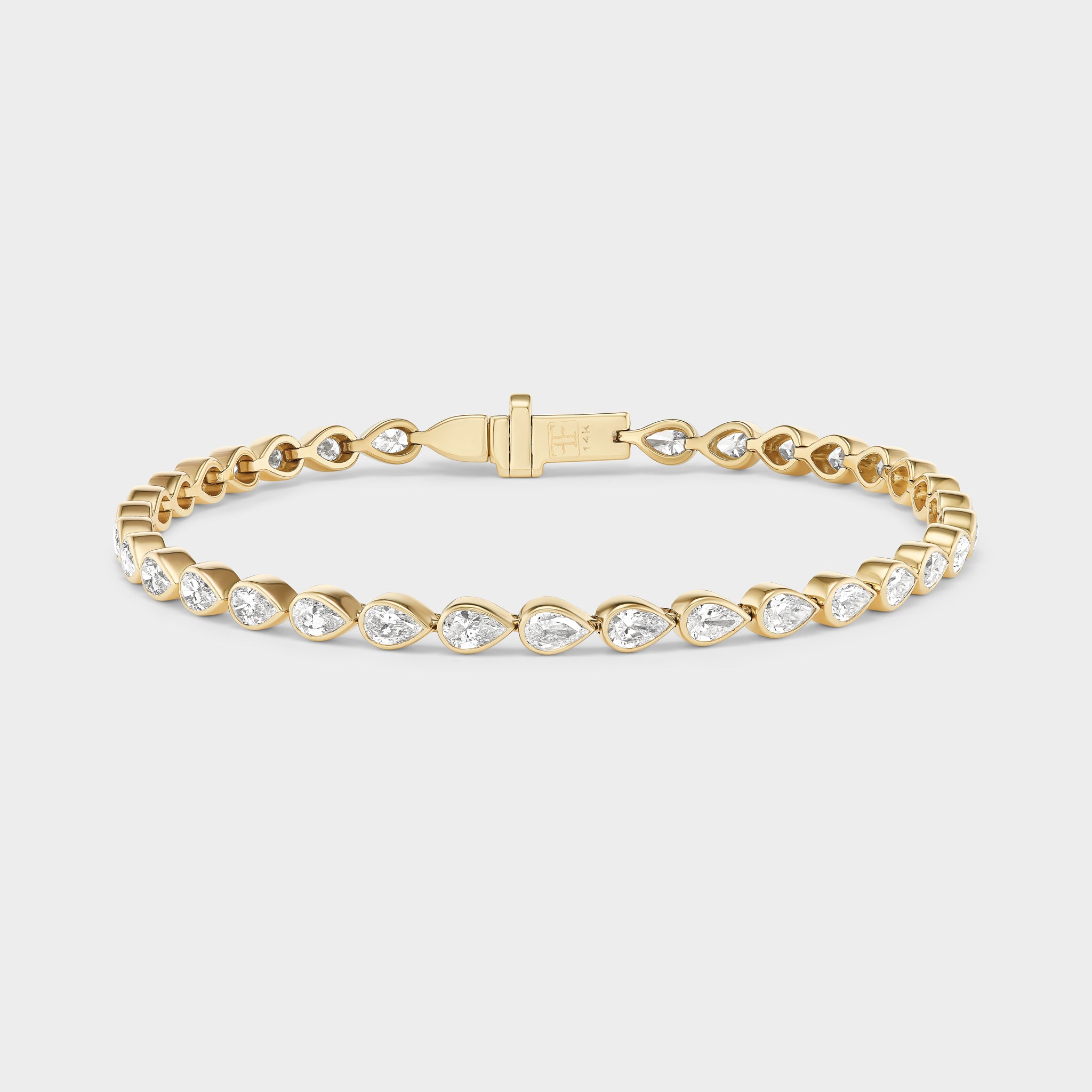 14K gold tennis bracelet with pear-cut lab-grown diamonds in bezel settings, perfect for everyday wear.