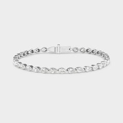 14K gold tennis bracelet with pear-cut lab-grown diamonds in bezel settings, ideal for everyday wear.