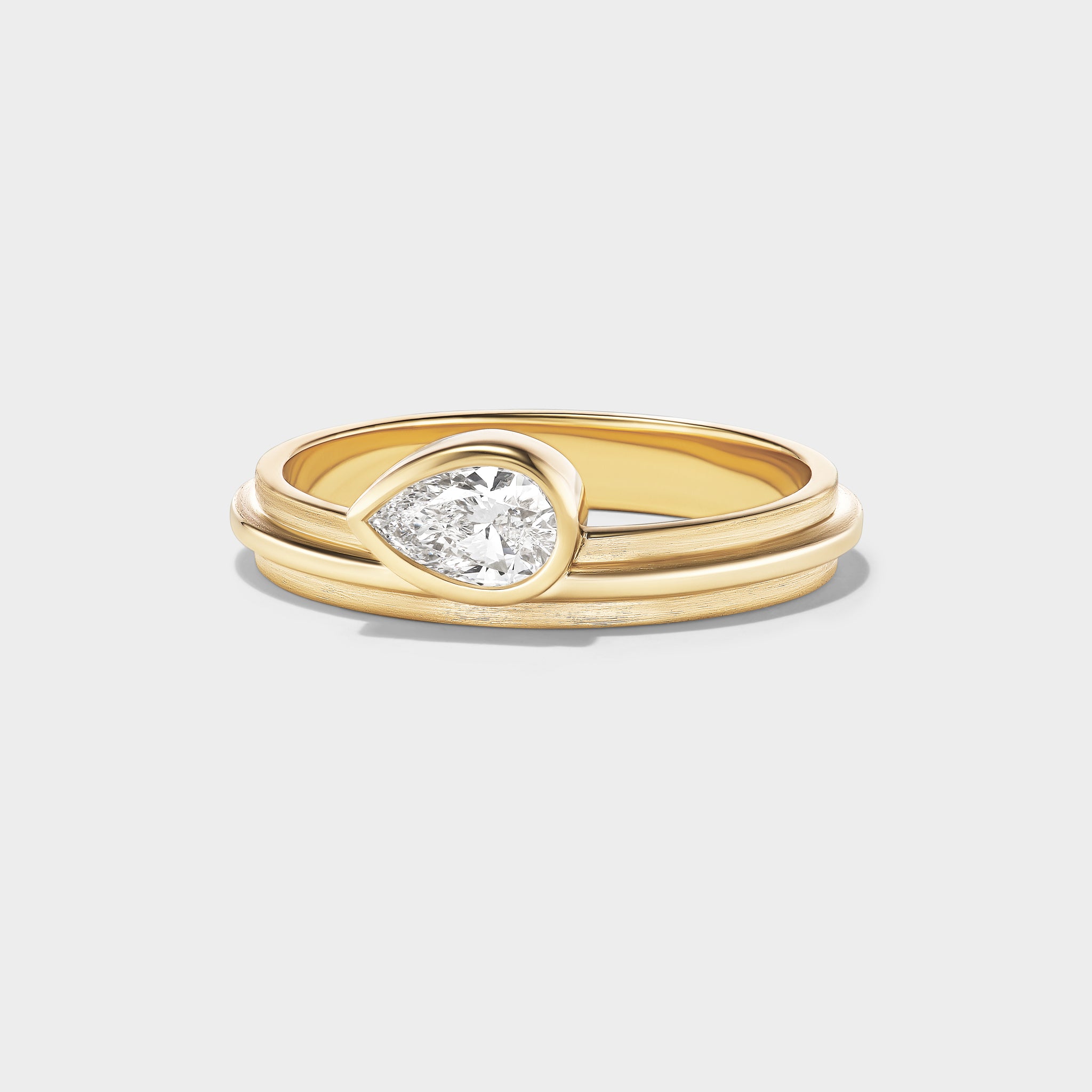 14K gold stacking ring with a pear-cut lab-grown diamond, perfect for everyday wear or stacking.