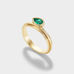 14K yellow gold stacking ring with a pear-cut Brazilian emerald in a triple-bezel setting.
