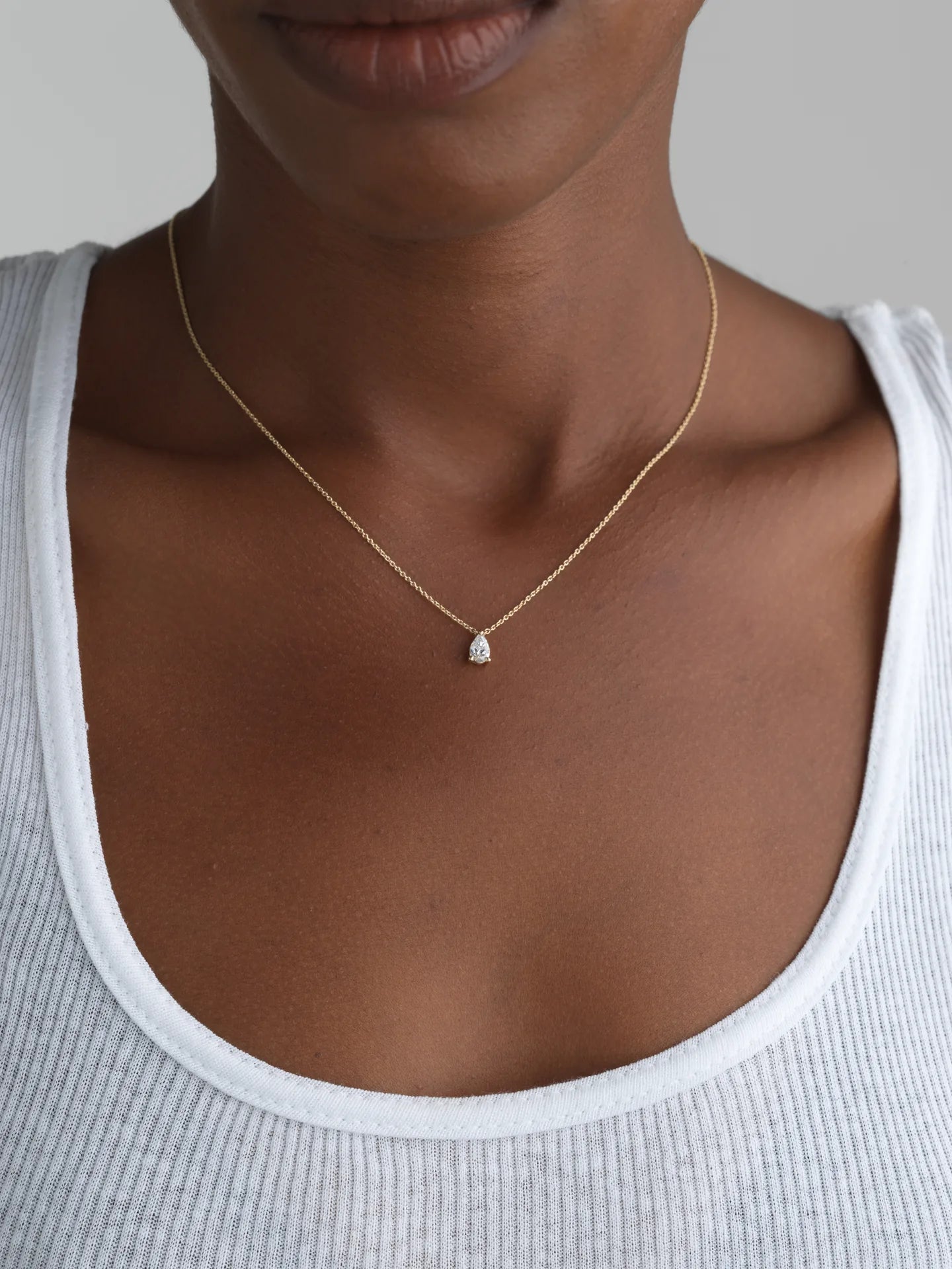 Minimalist 14K yellow gold necklace with a delicate pear-cut lab-grown diamond, perfect for everyday wear.