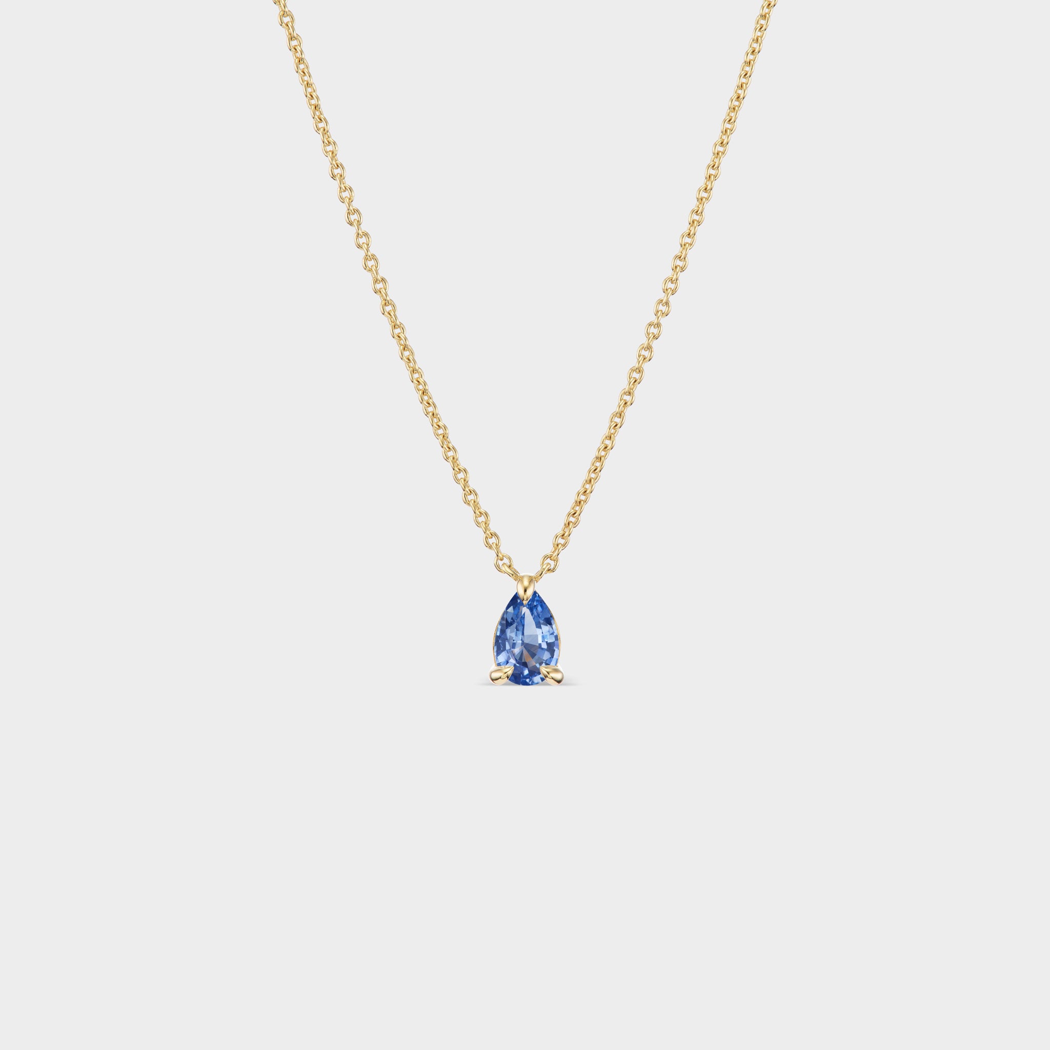 Minimalist 14K yellow gold necklace with a pear-cut blue sapphire, perfect for everyday wear or layering.