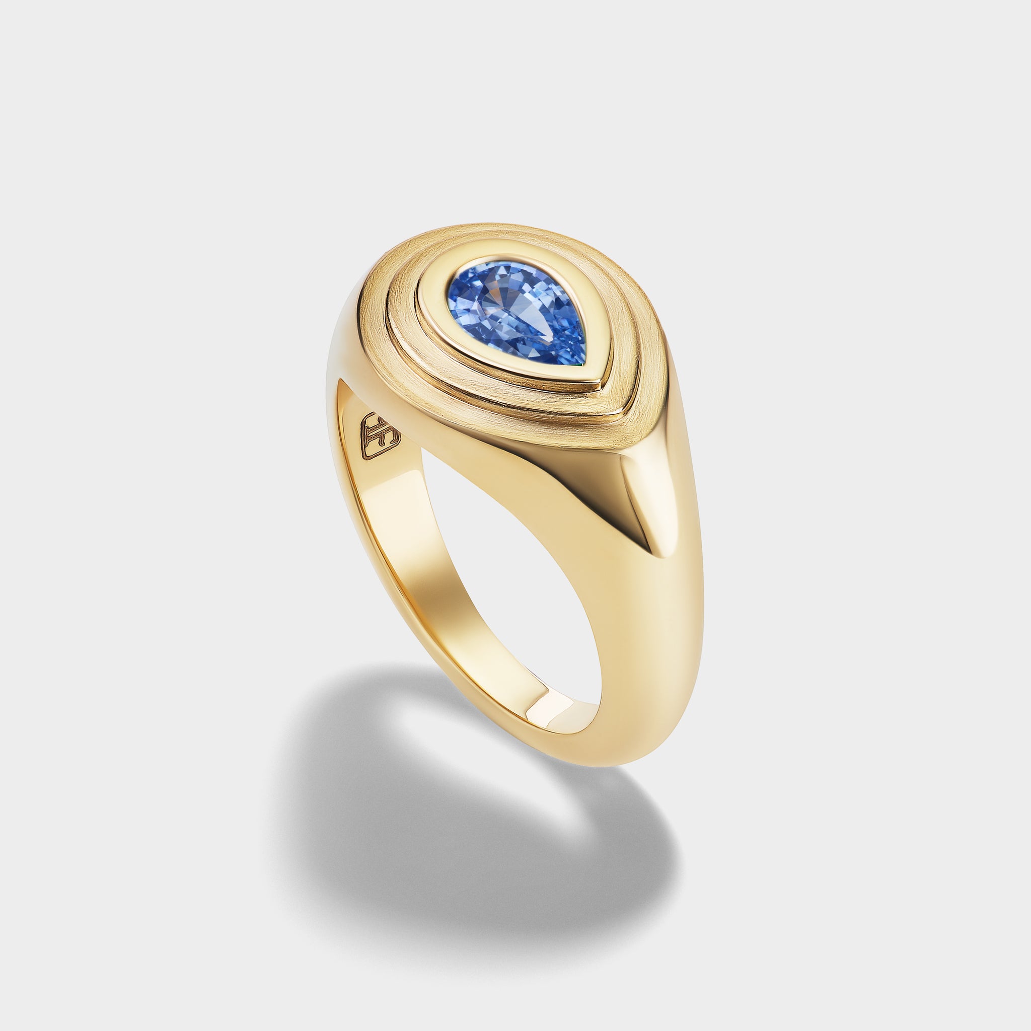 14K yellow gold signet ring with a pear-cut blue sapphire in a mixed-finish, triple-bezel setting, perfect as a pinky ring.