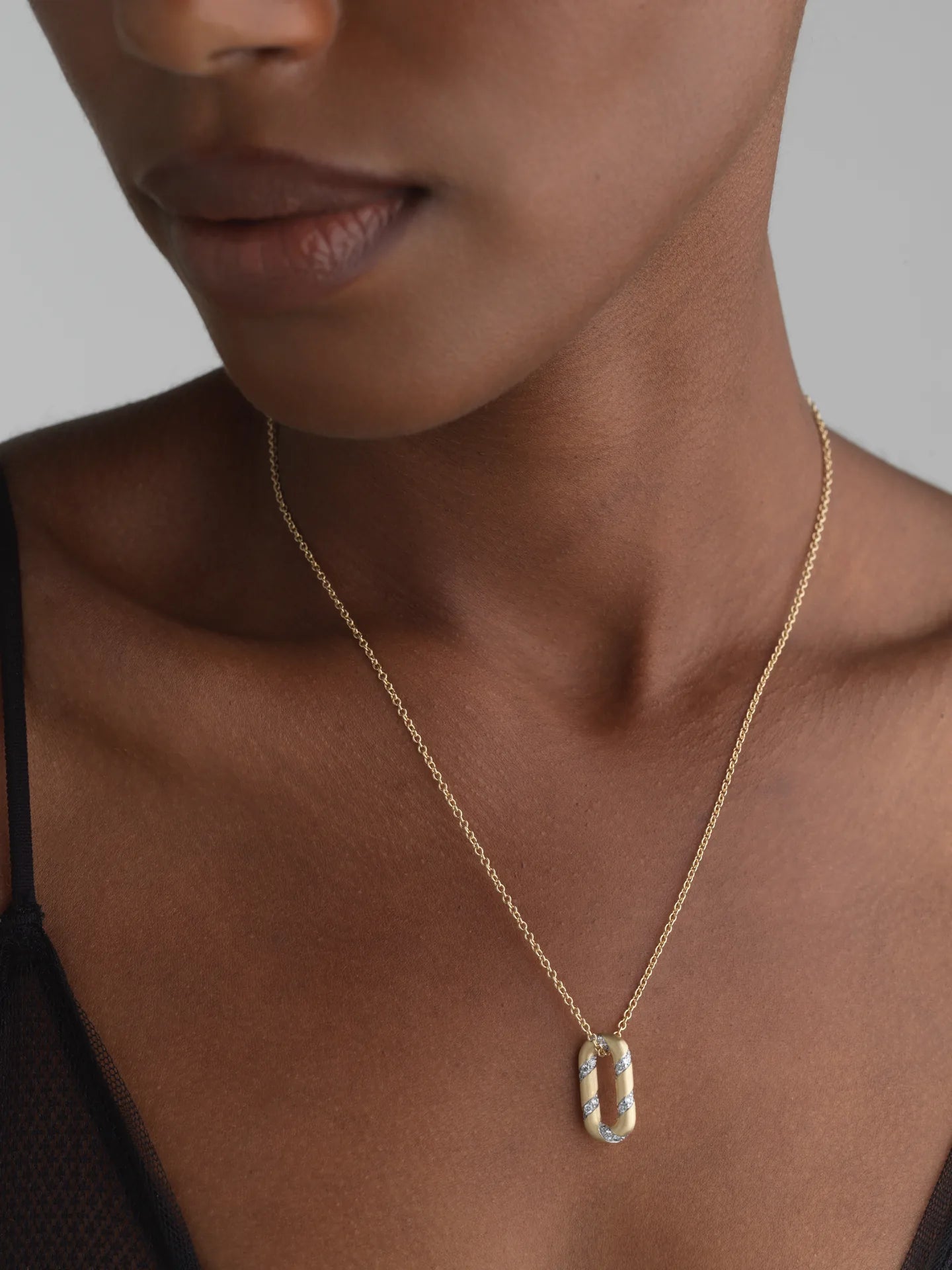 14k yellow gold small link charm with lab-grown diamonds on a delicate chain, perfect for everyday wear.