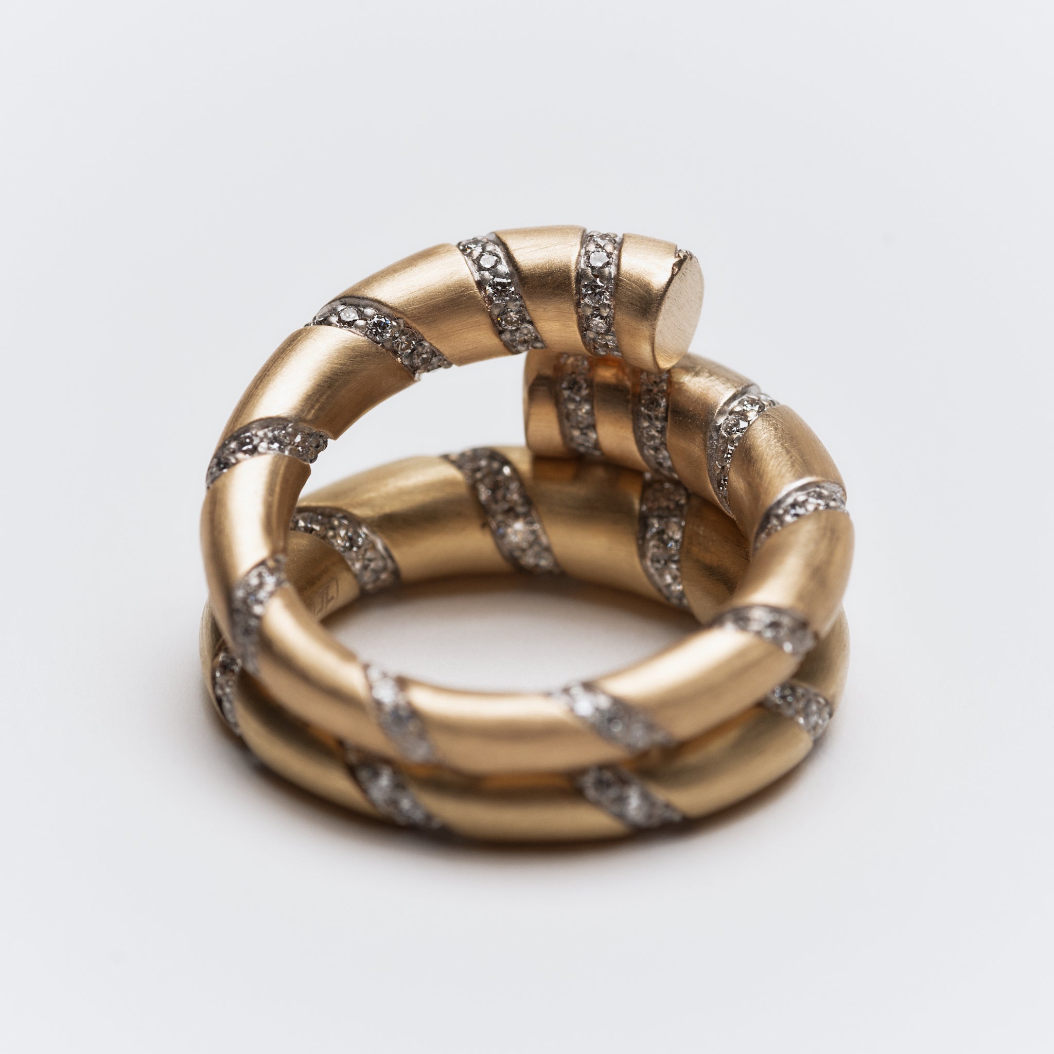 Sculptural 14k white gold twist ring with bezel-set lab-grown diamonds, perfect for stacking or a statement.